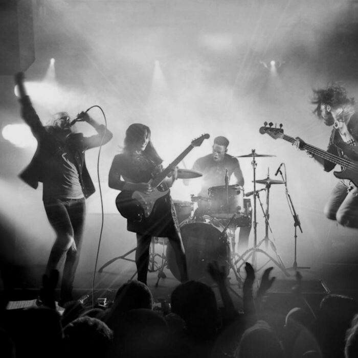 Black-and-white live stage performance representing Spark Academy continuous learning